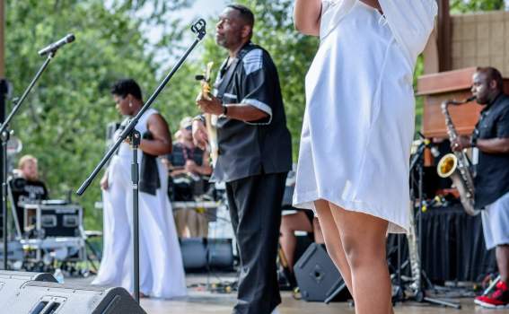 Woman Singing Onstage with Band
