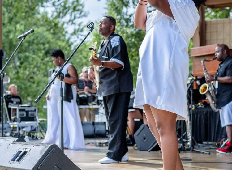 Woman Singing Onstage with Band