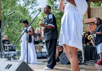 Woman Singing Onstage with Band