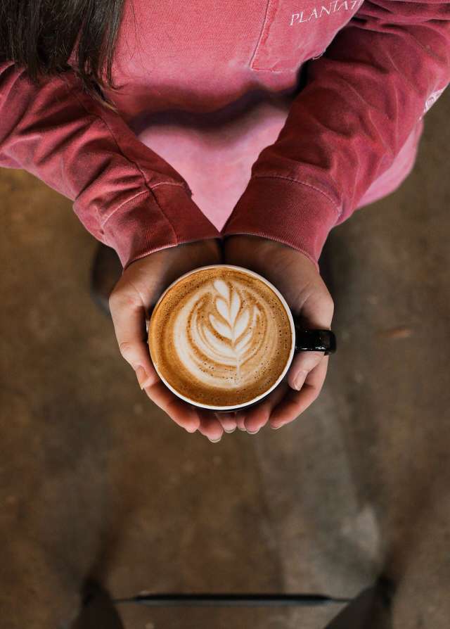Person Holding Flat White Coffee